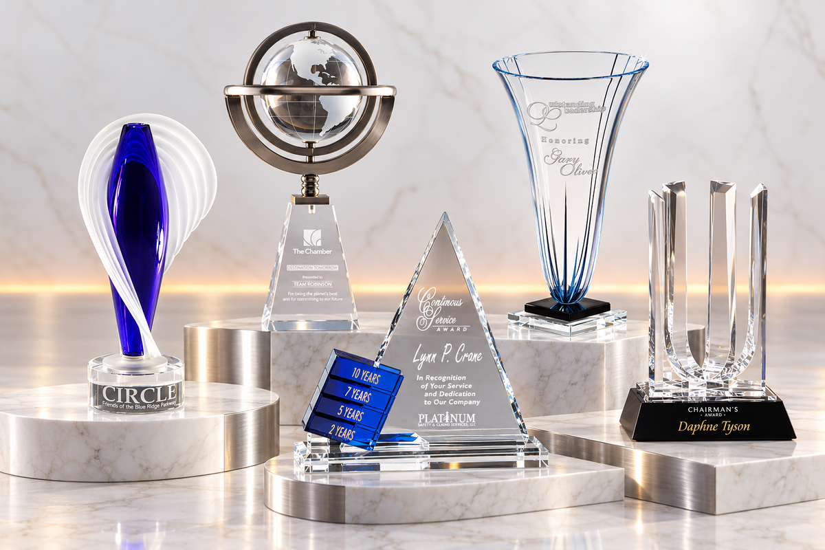 Art glass, globe award, Goal Setter, engraved vase and corporate award staged on white marble and brushed stainless